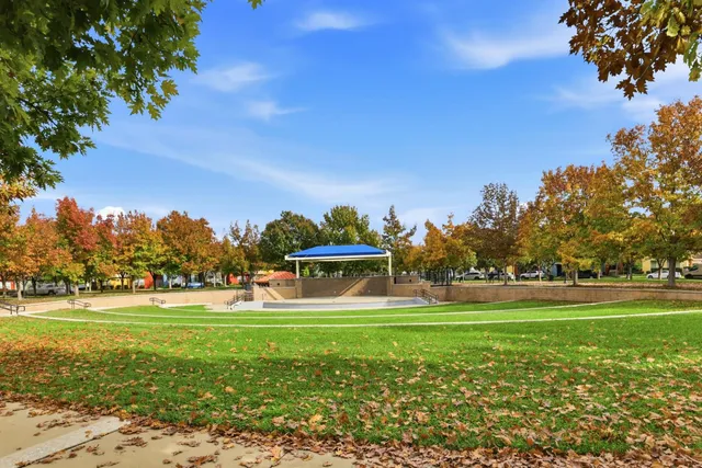 a view of a house with a yard and sitting area