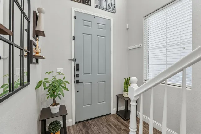 a vase of flowers sitting on a wooden floor