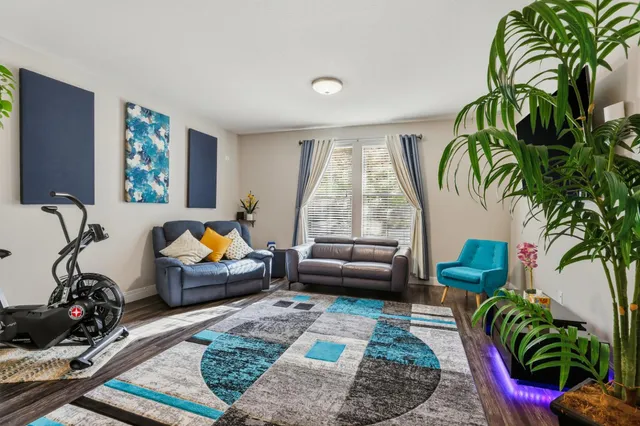 a living room with furniture chess board and a rug