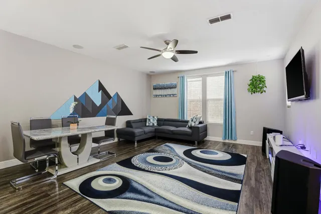 a work room with furniture and flat screen tv