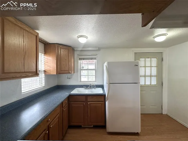a bathroom with a toilet a sink and a window