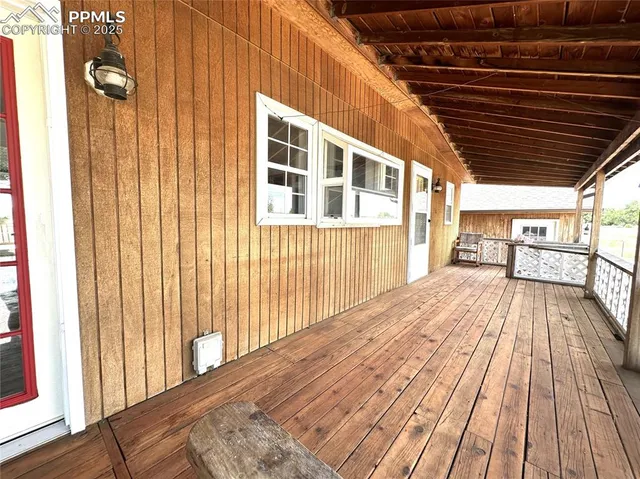 a view of backyard with a wooden deck