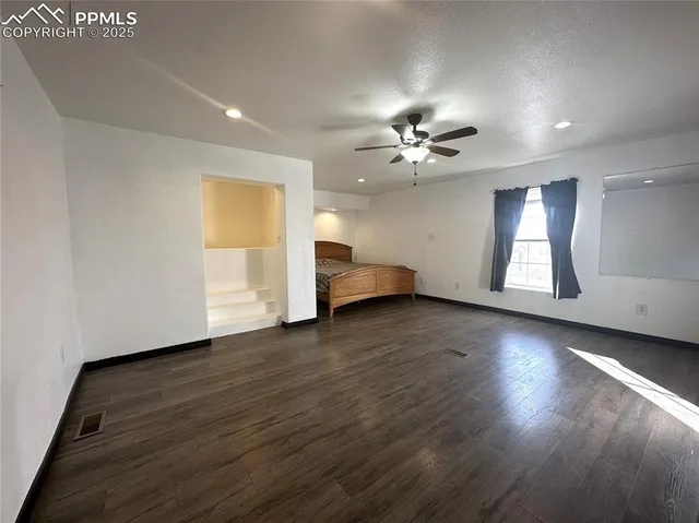 a view of a livingroom with wooden floor and window