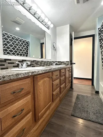 a kitchen with a refrigerator sink and cabinets