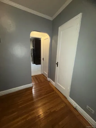 a view of a room with wooden floor