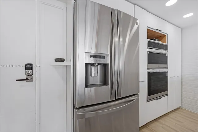 a metallic refrigerator freezer and a refrigerator in a kitchen