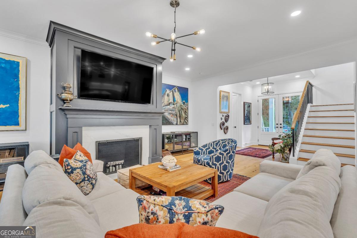 822 Dancy Avenue Savannah, GA 31419 - Photo 15 of 73 a living room with furniture a flat screen tv and a fireplace