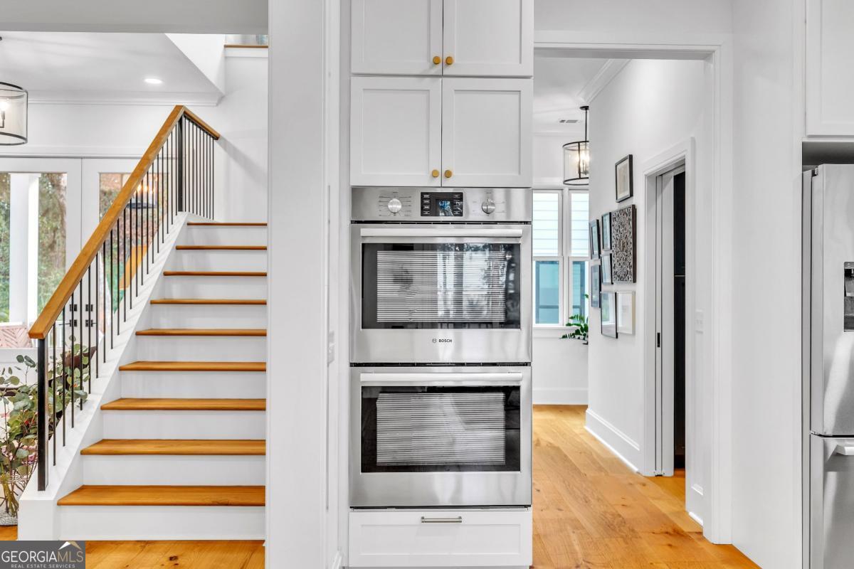 822 Dancy Avenue Savannah, GA 31419 - Photo 18 of 73 a kitchen with white cabinets and a stainless steel refrigerator stove top oven