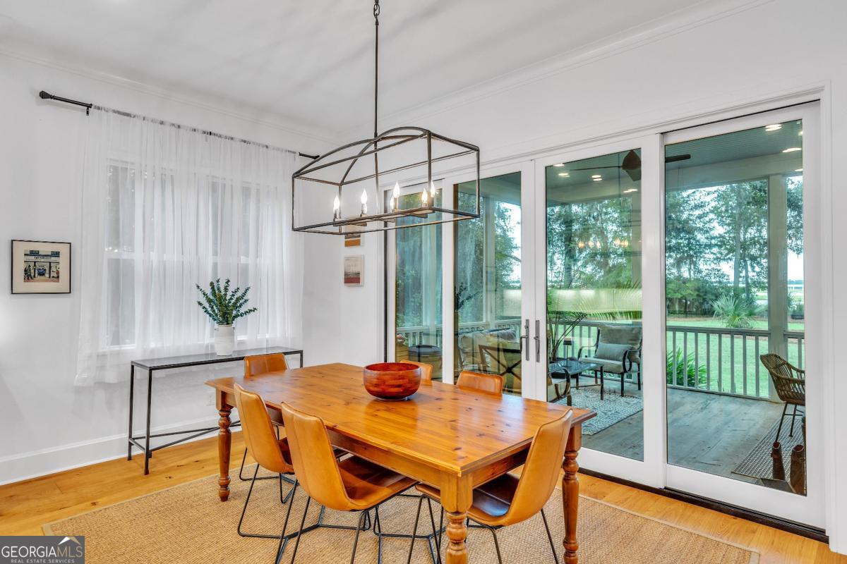 822 Dancy Avenue Savannah, GA 31419 - Photo 21 of 73 a dining room with a glass top table and chairs