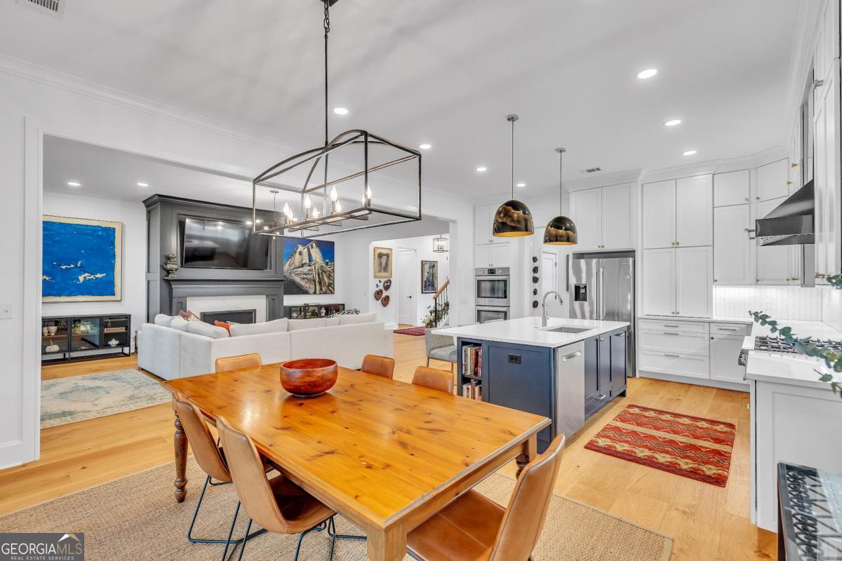 822 Dancy Avenue Savannah, GA 31419 - Photo 22 of 73 a kitchen with stainless steel appliances granite countertop a sink dishwasher a dining table and chairs with wooden floor