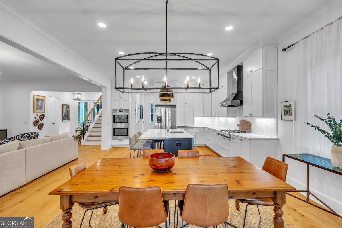 822 Dancy Avenue Savannah, GA 31419 - Photo 23 of 73 a view of a dining room with furniture a chandelier and wooden floor