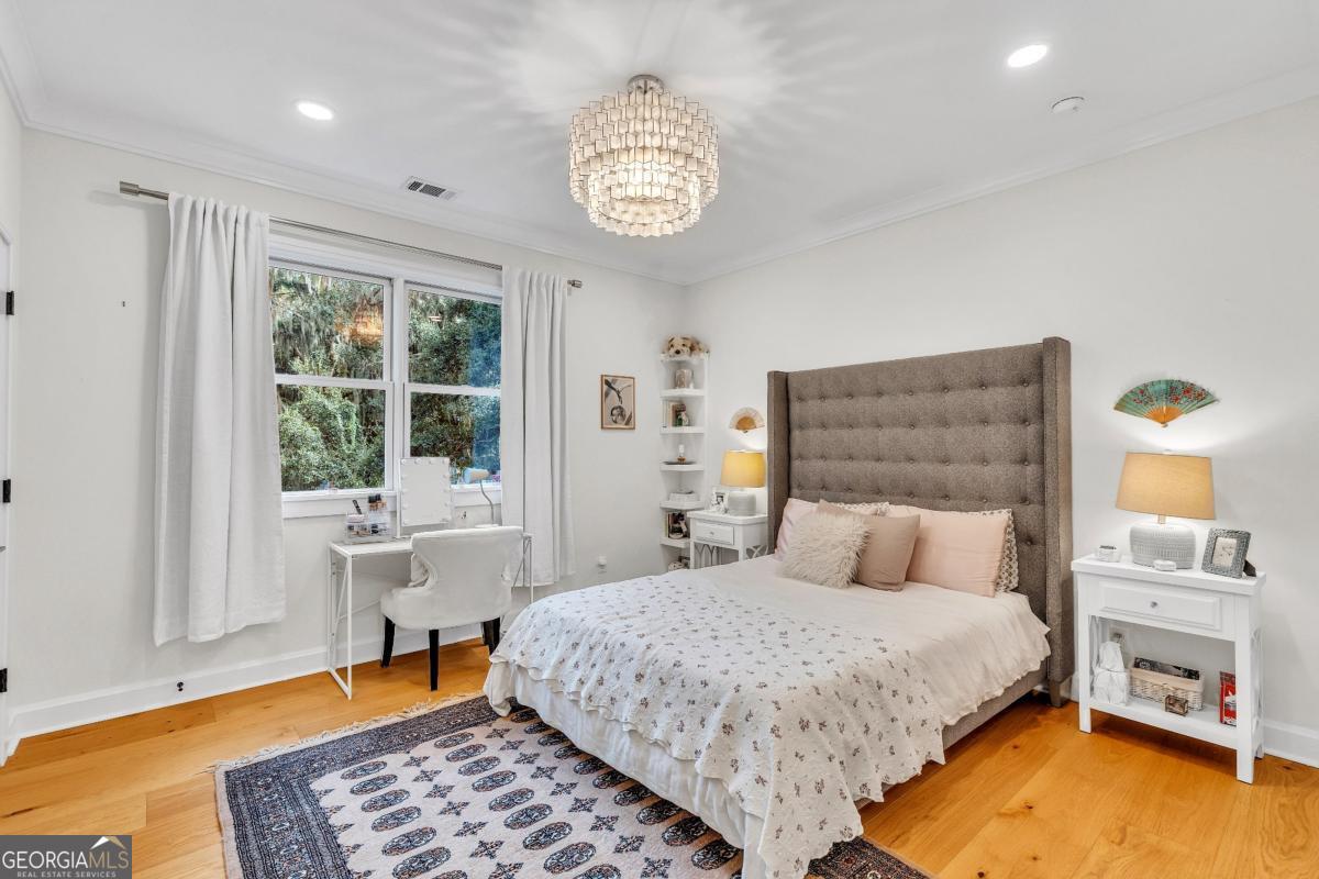822 Dancy Avenue Savannah, GA 31419 - Photo 45 of 73 a bedroom with a bed and a table in it