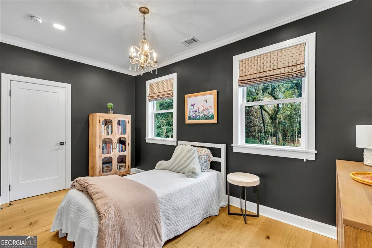 822 Dancy Avenue Savannah, GA 31419 - Photo 57 of 73 a bedroom with a bed chandelier and a window
