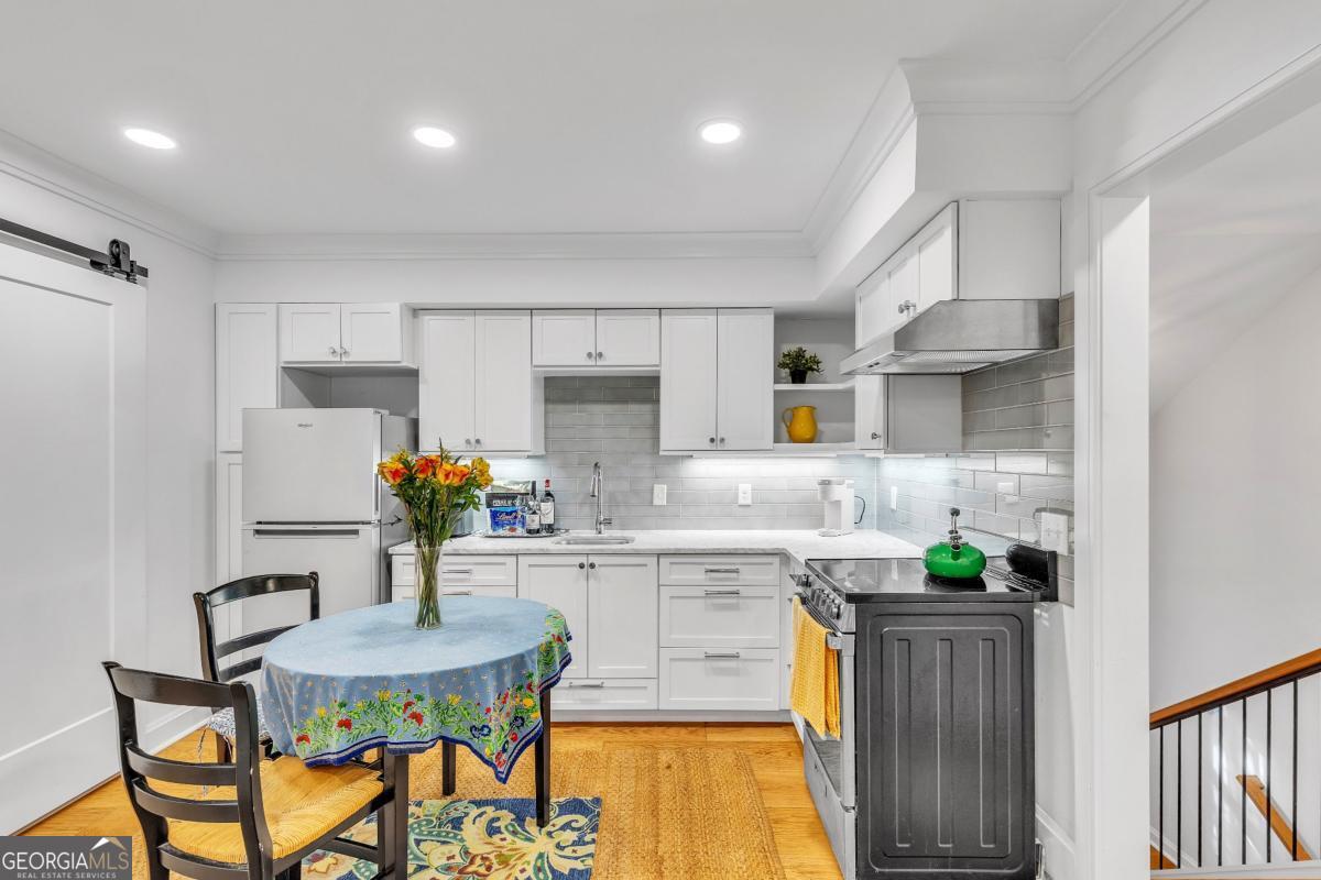 822 Dancy Avenue Savannah, GA 31419 - Photo 65 of 73 a kitchen with stainless steel appliances kitchen island granite countertop a sink and cabinets