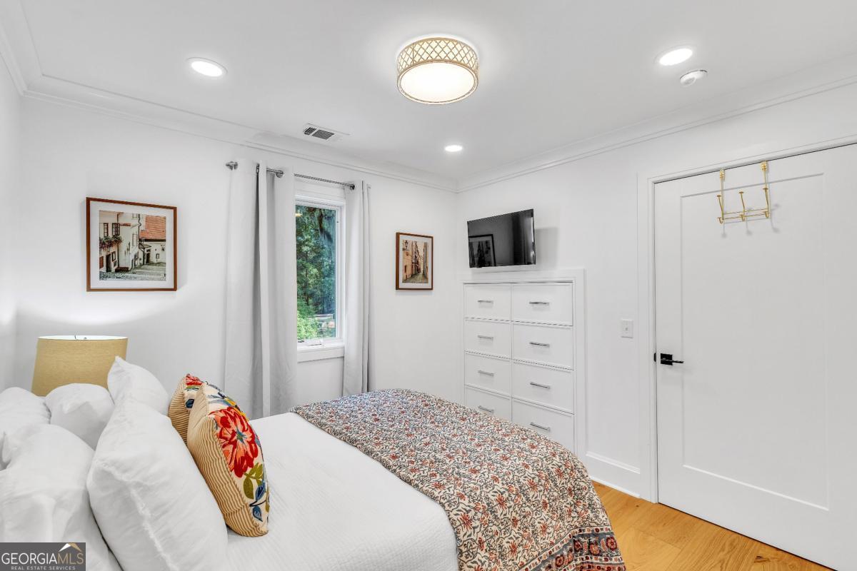 822 Dancy Avenue Savannah, GA 31419 - Photo 68 of 73 a bedroom with a bed and a flat screen tv