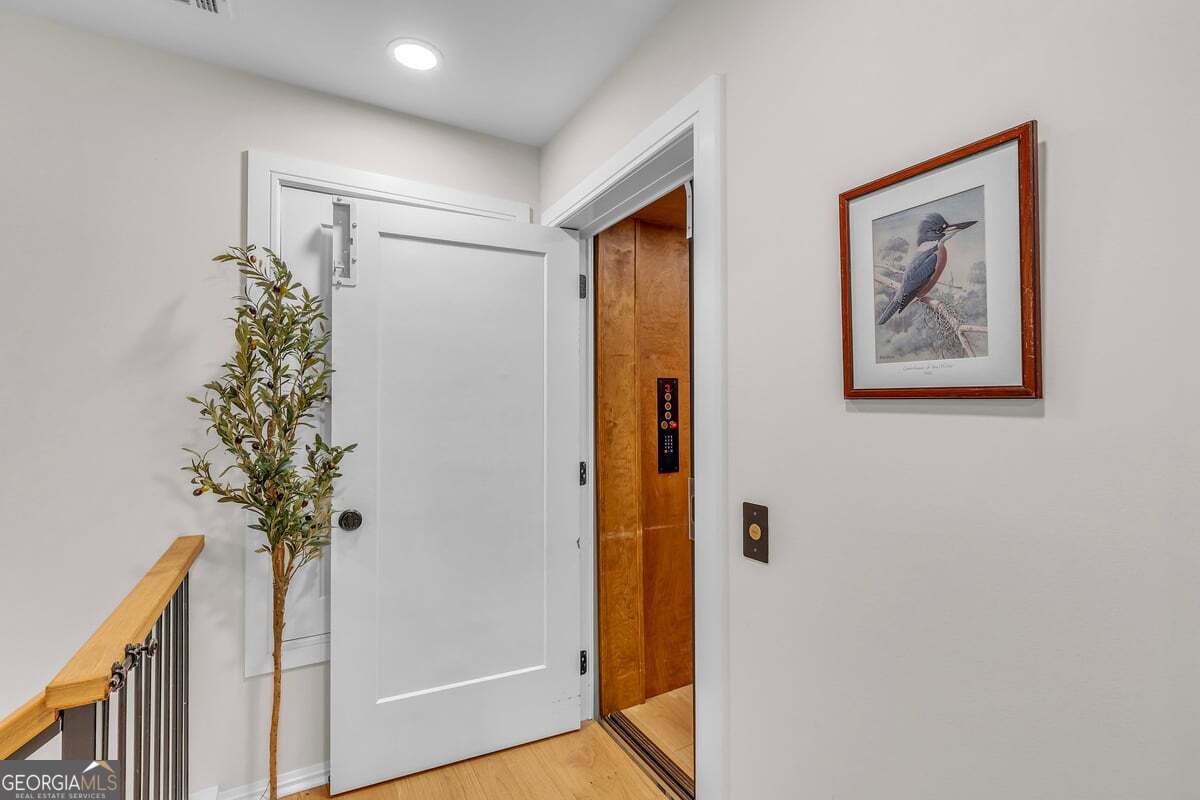 822 Dancy Avenue Savannah, GA 31419 - Photo 69 of 73 a view of a hallway with wooden floor and a potted plant