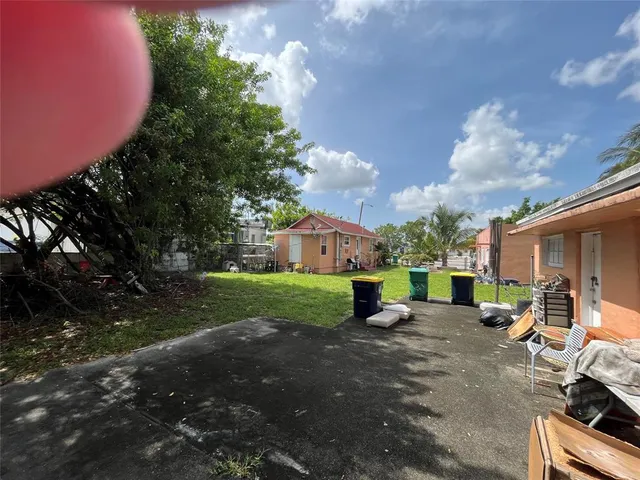a view of a yard with table and chairs and a fire pit