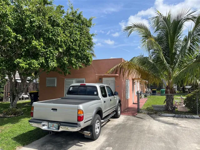 a view of a chair and table in backyard of the house