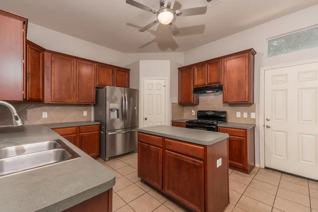 a kitchen with a stove sink and a refrigerator
