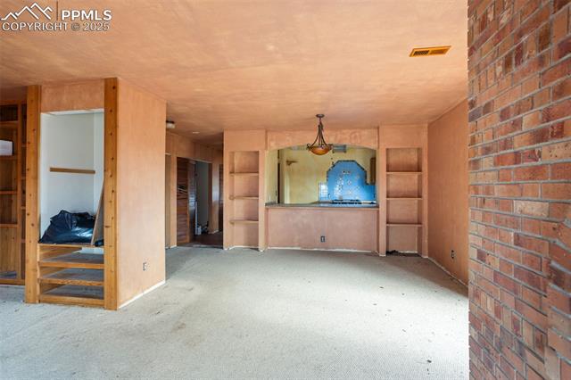 4775 Meridian Road Peyton, CO 80831 - Photo 8 of 25 Living room featuring carpet floors and built in features