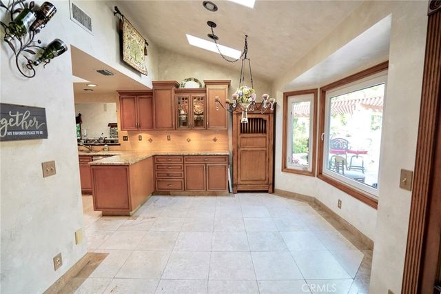 a bathroom with a granite countertop sink a mirror and vanity