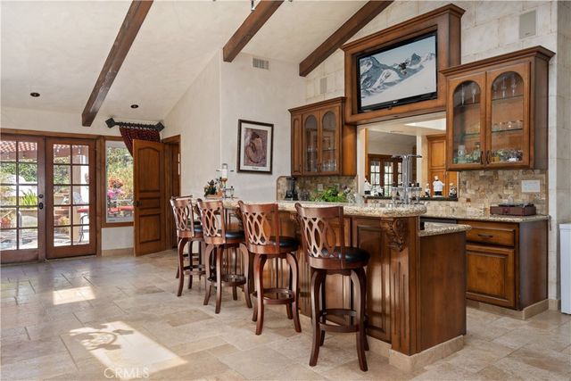 a bathroom with a granite countertop sink mirror and a shower