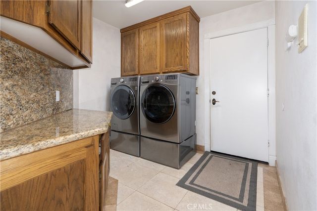 a view of a livingroom with a fireplace a chandelier and wooden floor