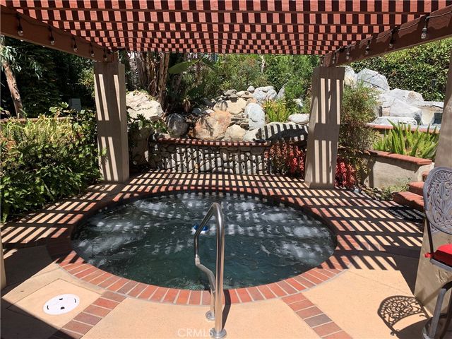 a front view of a house with a tree