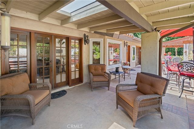 an aerial view of a house with a yard and large trees