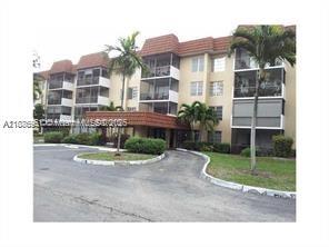 4166 Inverrary Drive, Unit 405 Lauderhill, FL 33319 - Photo 2 of 11 a front view of a house with garden