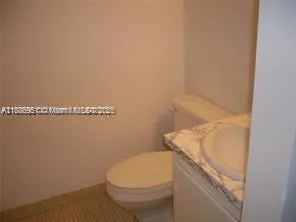 a bathroom with a toilet and a sink