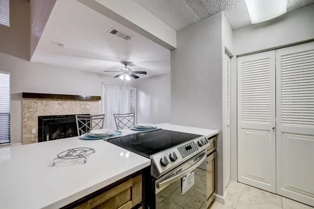 a view of a kitchen with workspace and fireplace