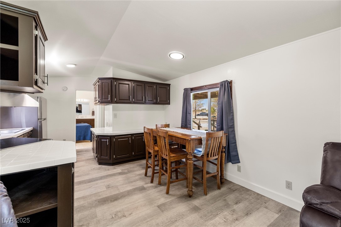 1771 East Brian Road Pahrump, NV 89048 - Photo 16 of 29 Dining space with lofted ceiling and light wood-type flooring