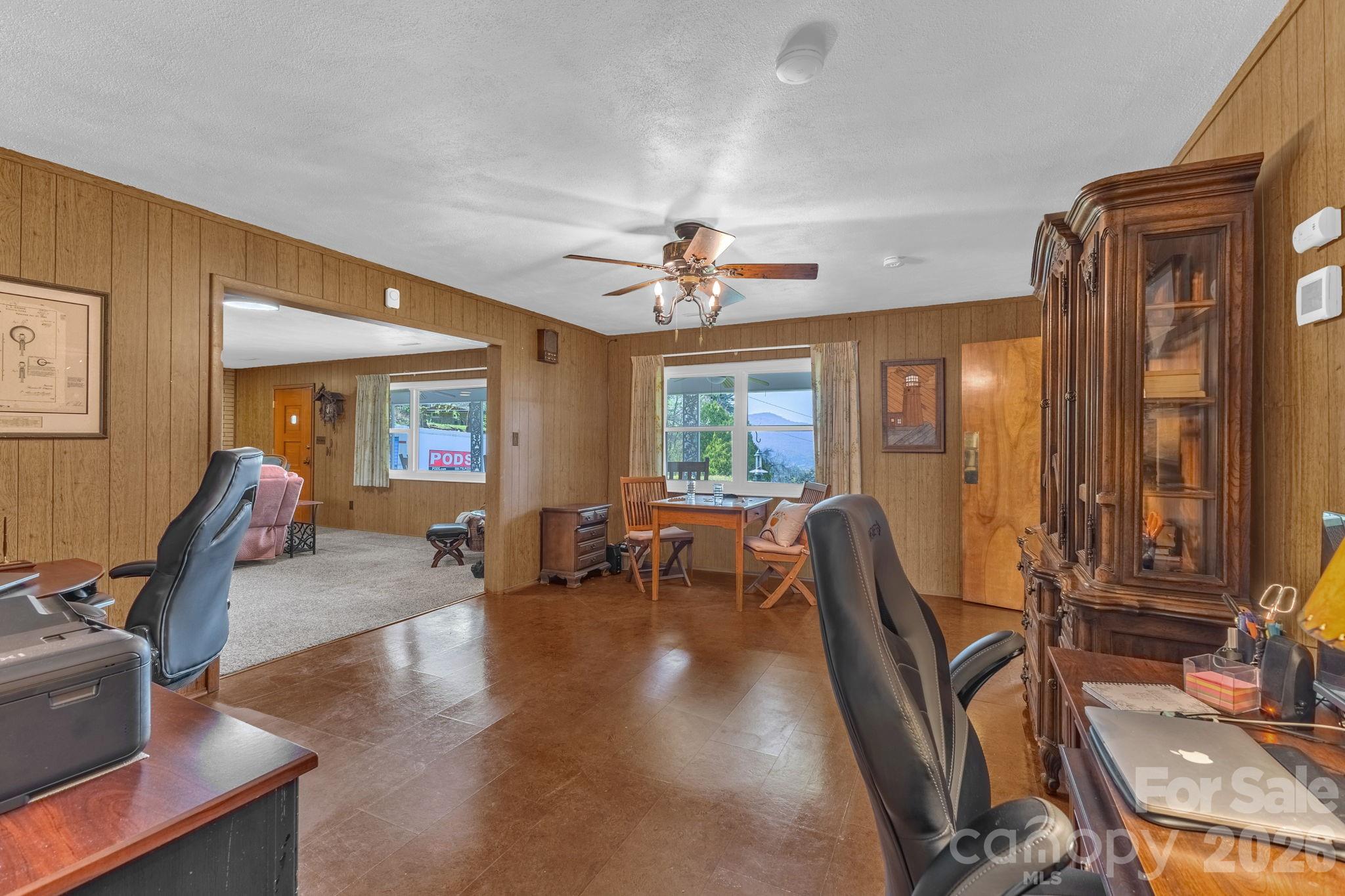 87 Rockwood Road Waynesville, NC 28786 - Photo 12 of 45 a living room with furniture a flat screen tv and large windows