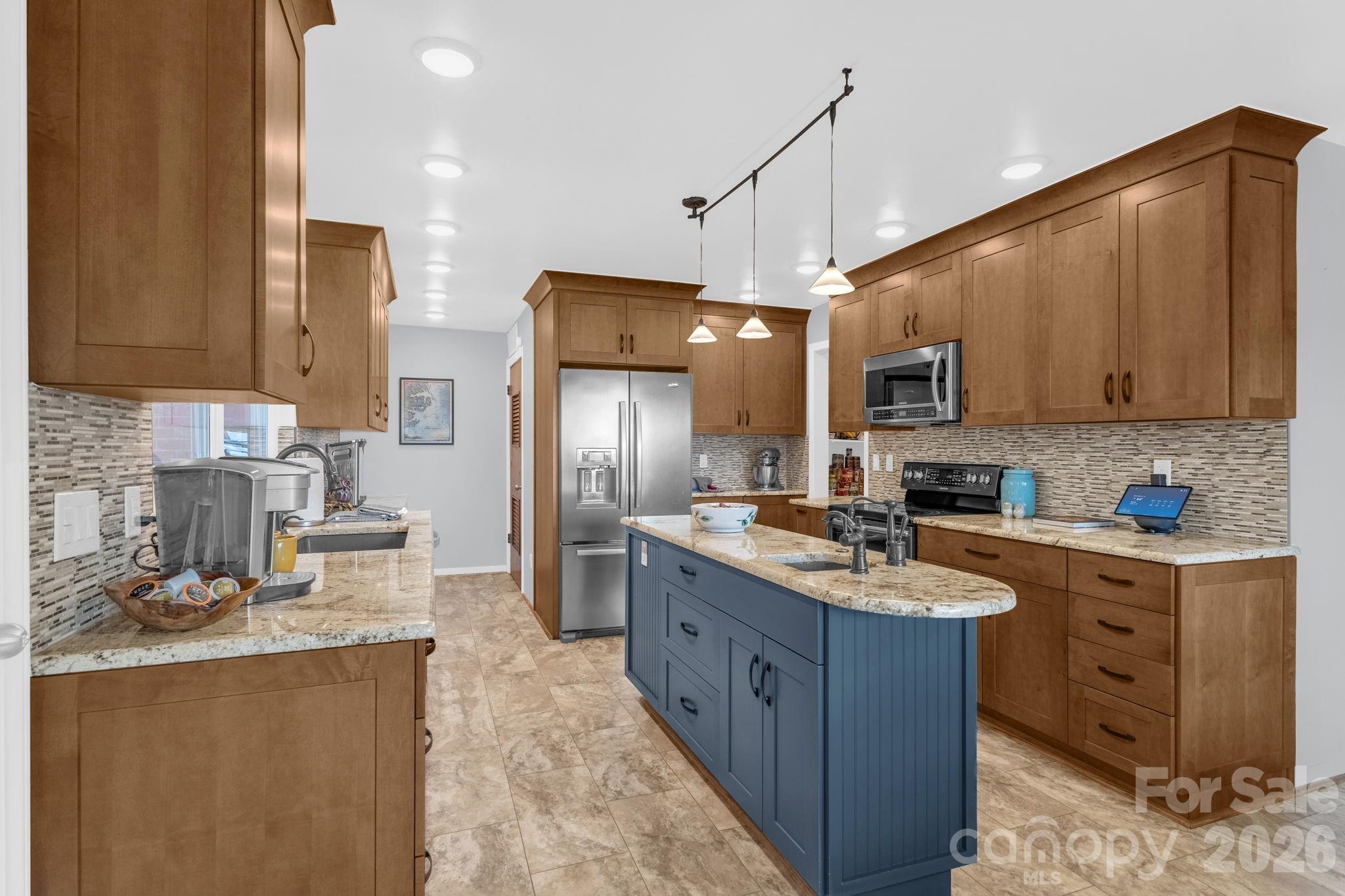 87 Rockwood Road Waynesville, NC 28786 - Photo 16 of 45 a kitchen with stainless steel appliances granite countertop a sink stove and refrigerator