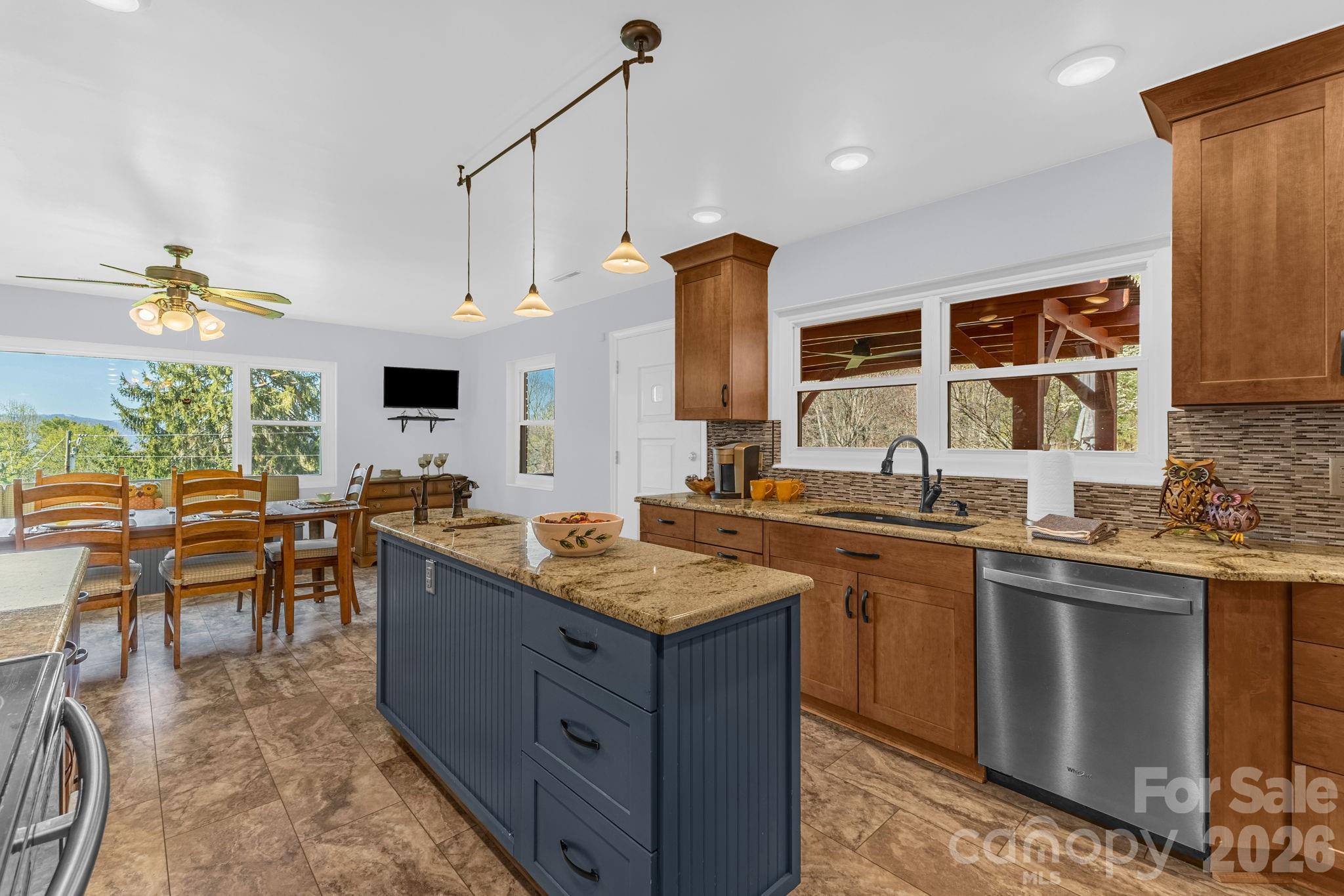 87 Rockwood Road Waynesville, NC 28786 - Photo 18 of 45 a kitchen with granite countertop a sink stove and cabinets