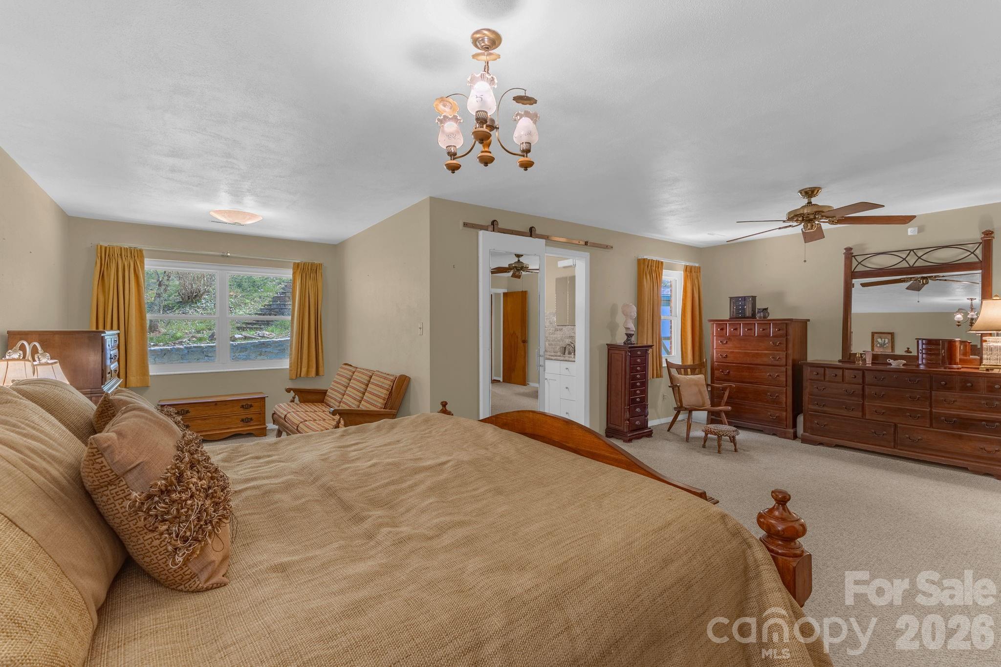 87 Rockwood Road Waynesville, NC 28786 - Photo 21 of 45 a bed room with a bed mirror and a window