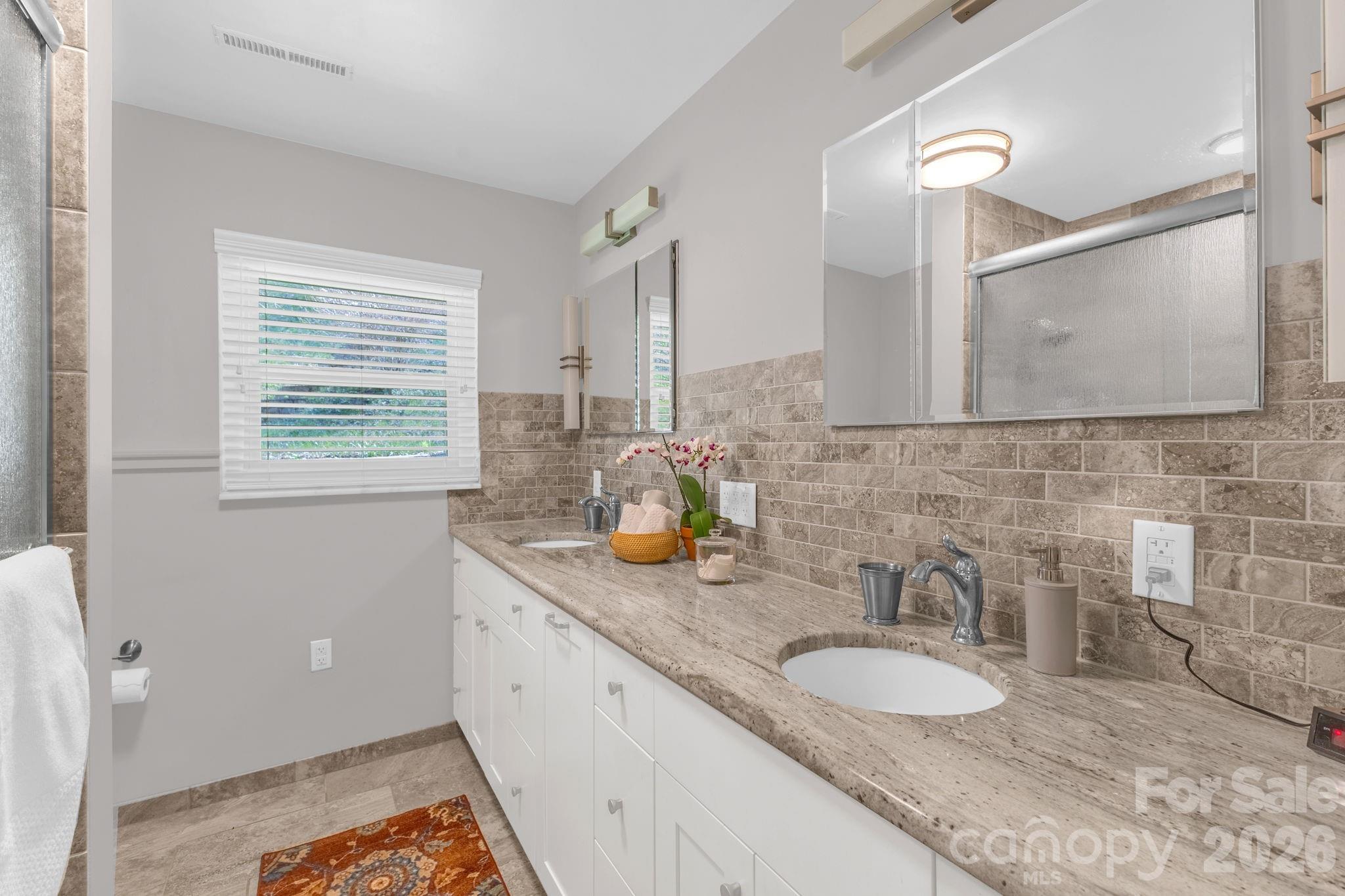 87 Rockwood Road Waynesville, NC 28786 - Photo 23 of 45 a bathroom with a granite countertop sink and a mirror