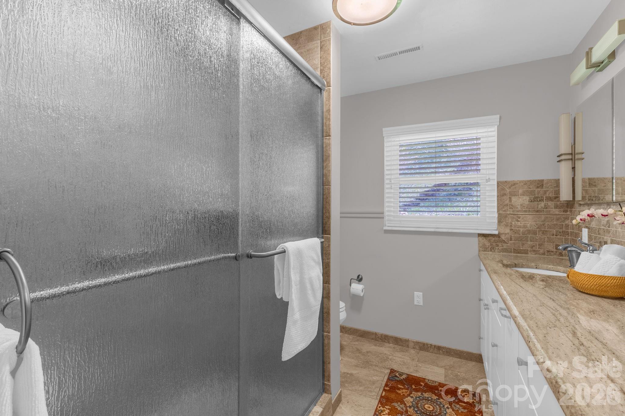 87 Rockwood Road Waynesville, NC 28786 - Photo 24 of 45 a bathroom with a tub and a window