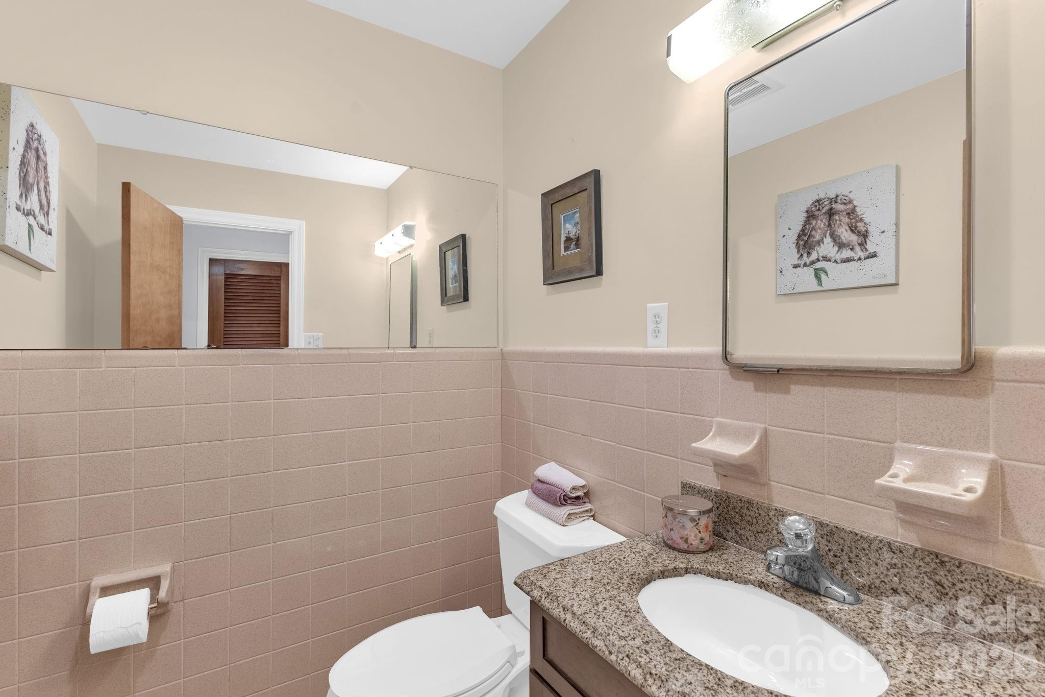87 Rockwood Road Waynesville, NC 28786 - Photo 30 of 45 a bathroom with a granite countertop sink mirror and toilet