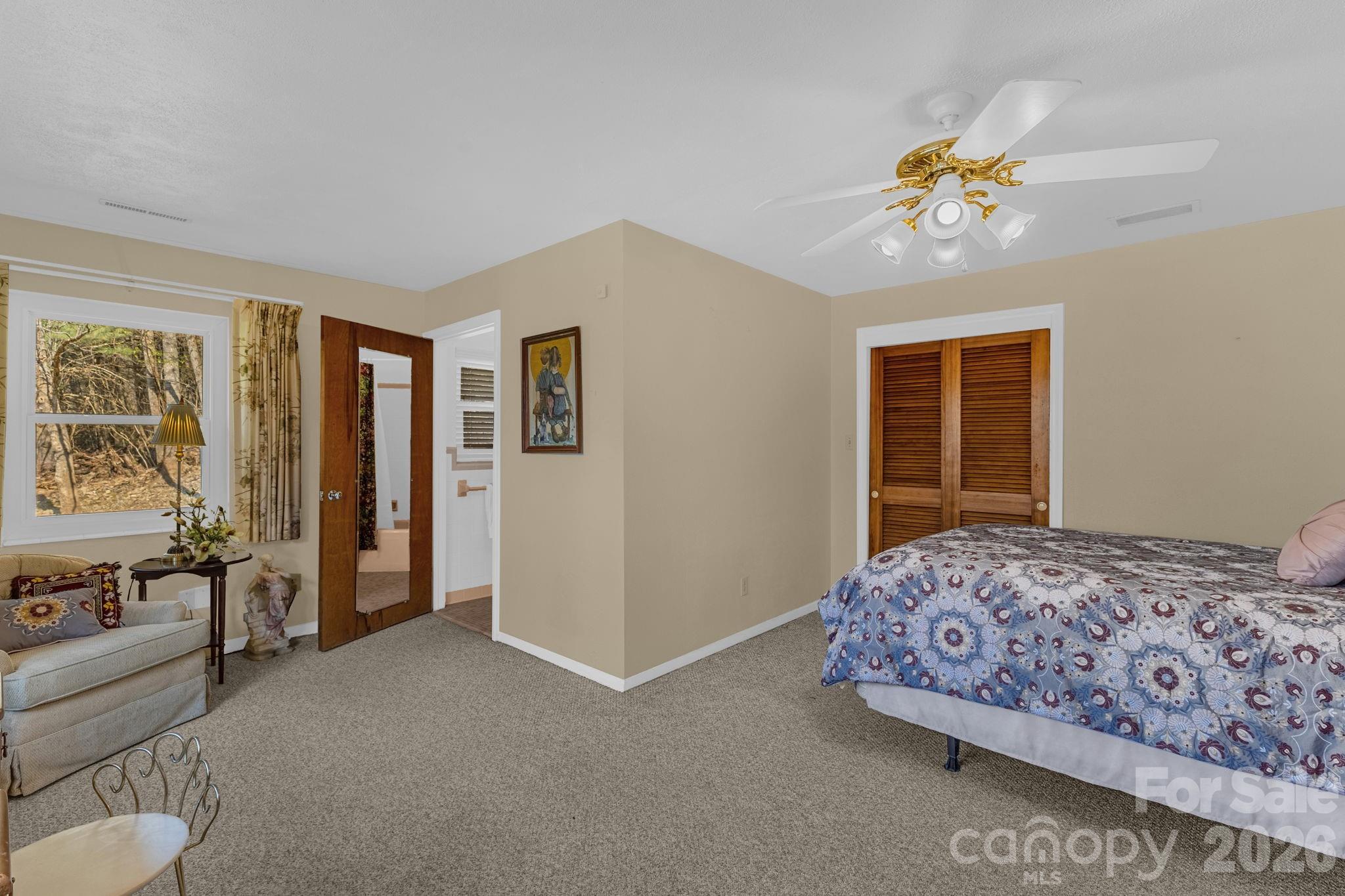 87 Rockwood Road Waynesville, NC 28786 - Photo 31 of 45 a bedroom with a large bed and a chandelier