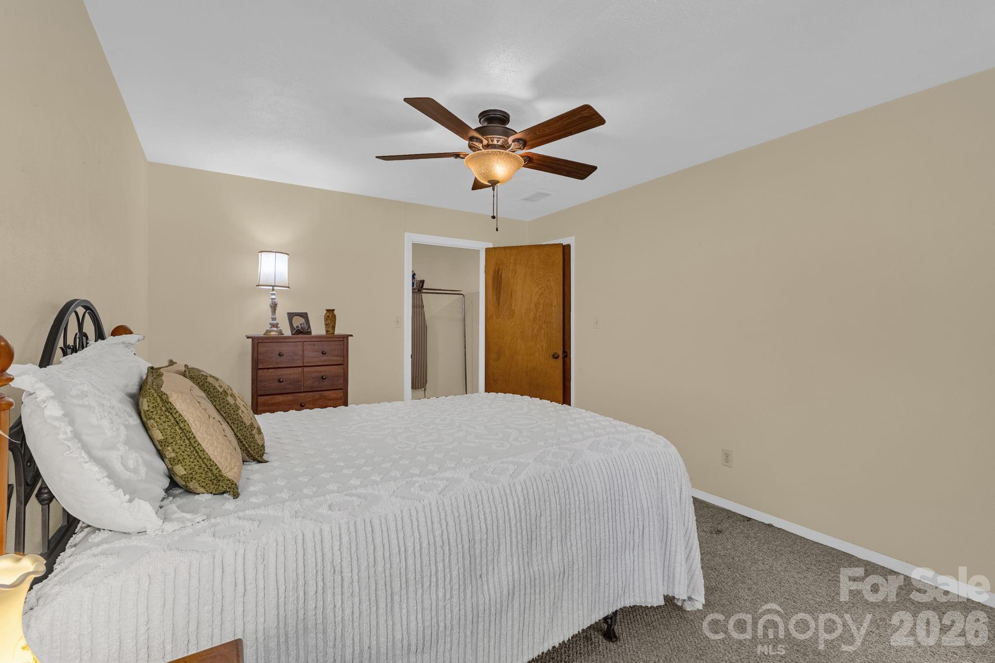 87 Rockwood Road Waynesville, NC 28786 - Photo 35 of 45 a bed room with a bed and a ceiling fan