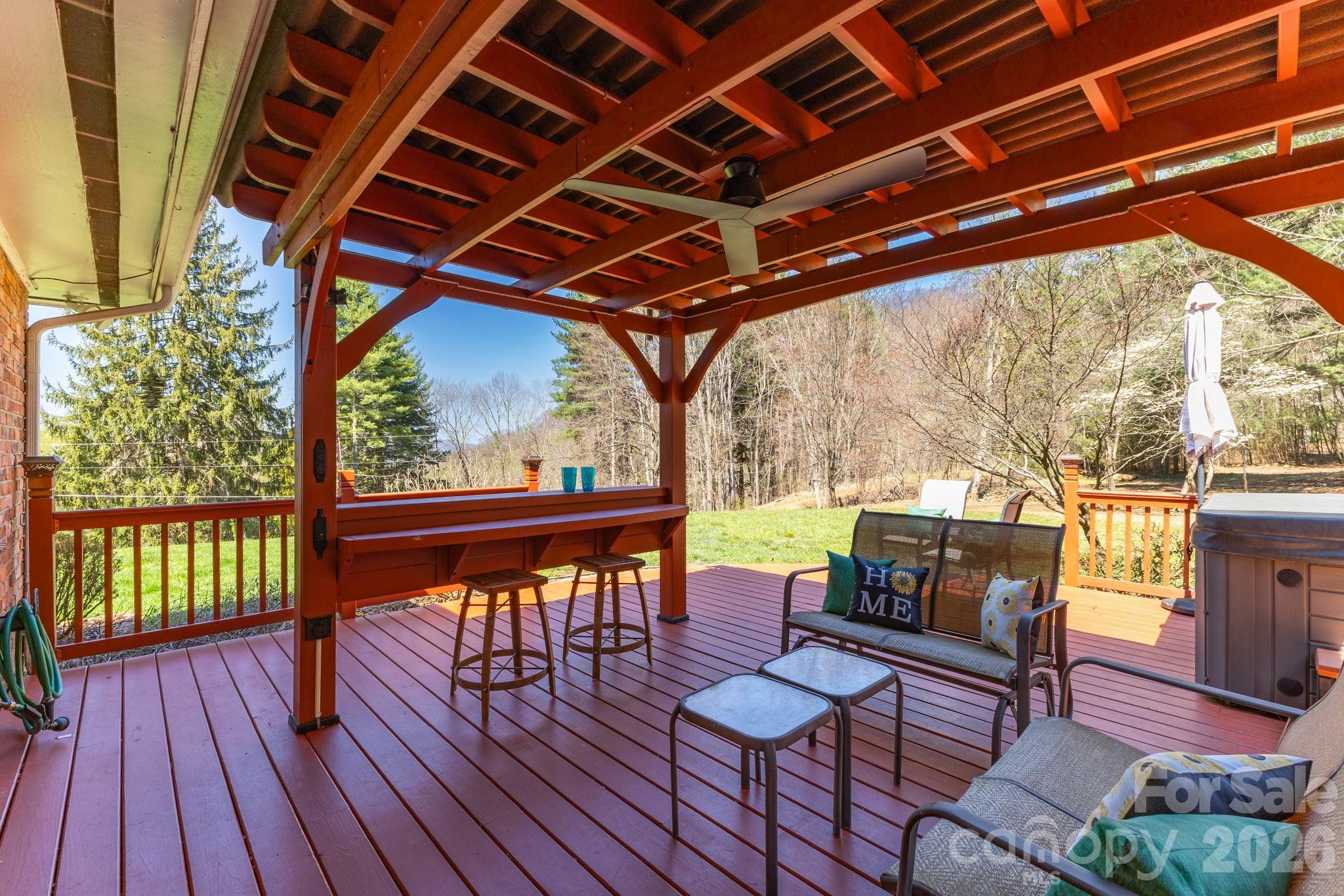 87 Rockwood Road Waynesville, NC 28786 - Photo 37 of 45 a porch with wooden floor and outdoor seating