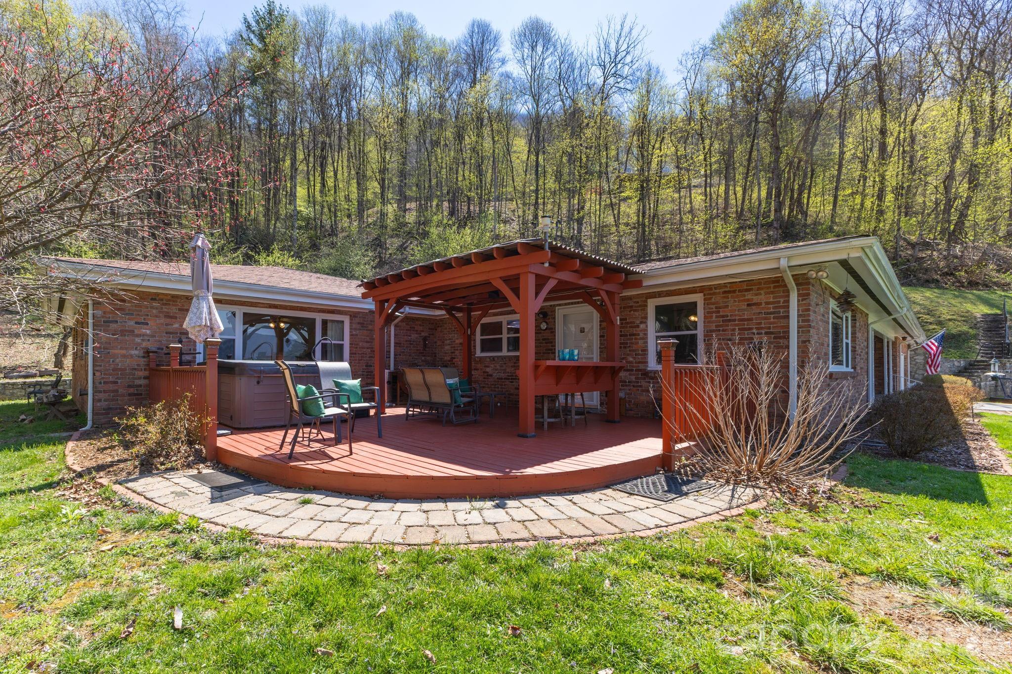 87 Rockwood Road Waynesville, NC 28786 - Photo 38 of 45 a view of a house with backyard porch and sitting area