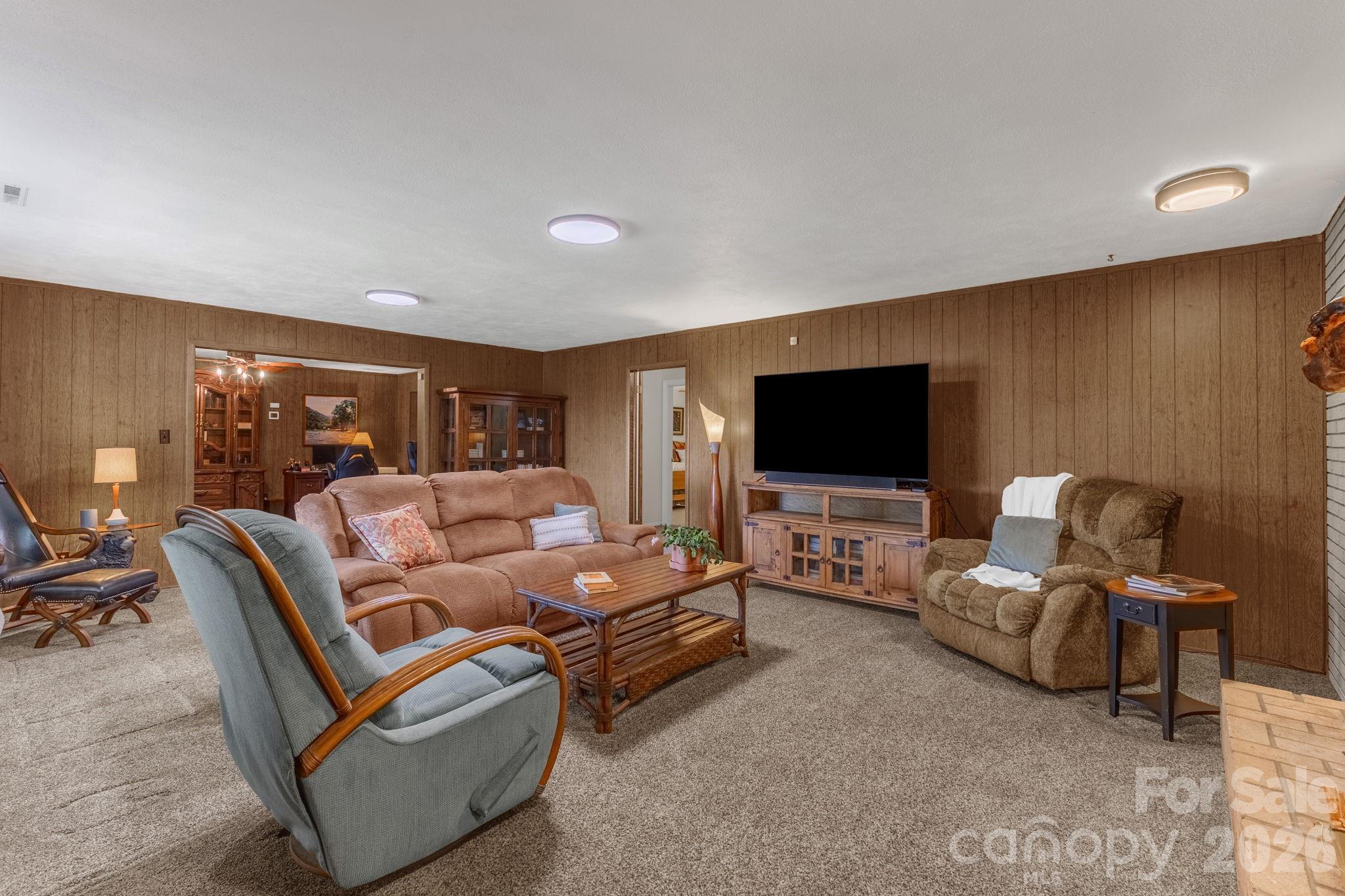 87 Rockwood Road Waynesville, NC 28786 - Photo 7 of 45 a living room with furniture and a flat screen tv