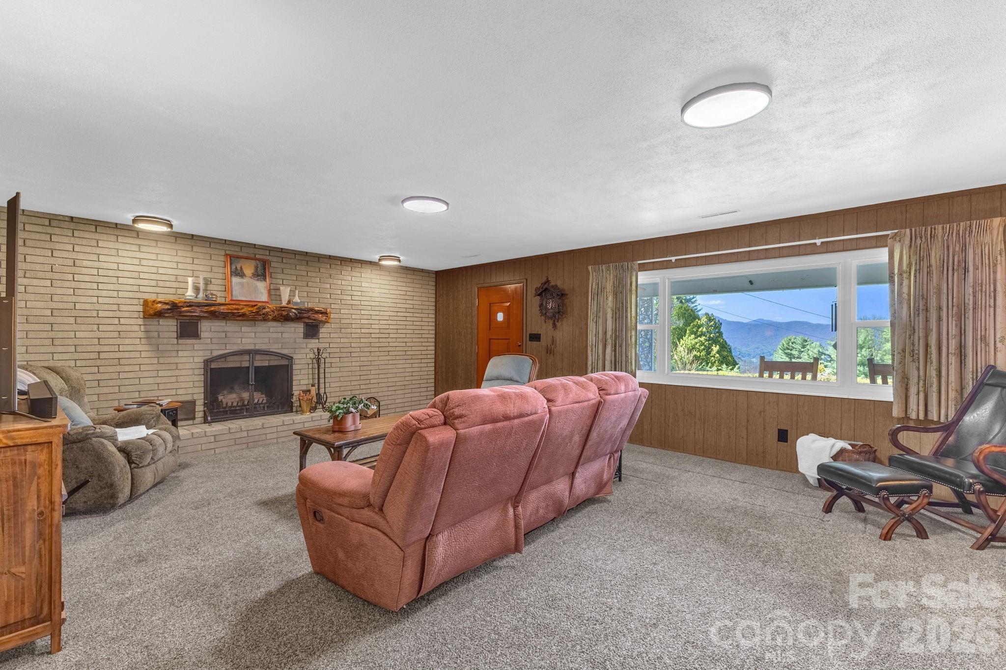 87 Rockwood Road Waynesville, NC 28786 - Photo 9 of 45 a living room with furniture and a fireplace