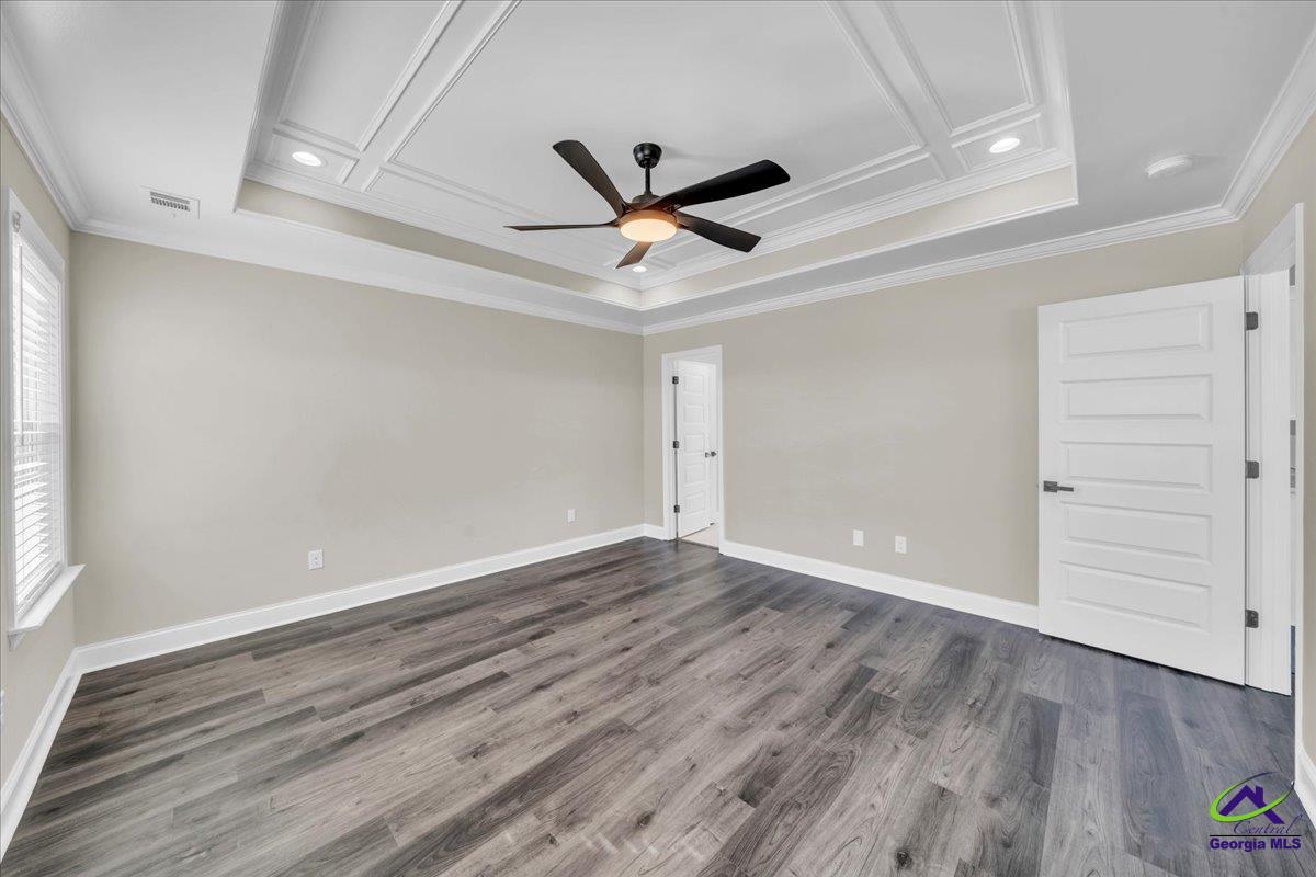 103 Early Drive Byron, GA 31008 - Photo 24 of 56 an empty room with wooden floor ceiling fan and windows