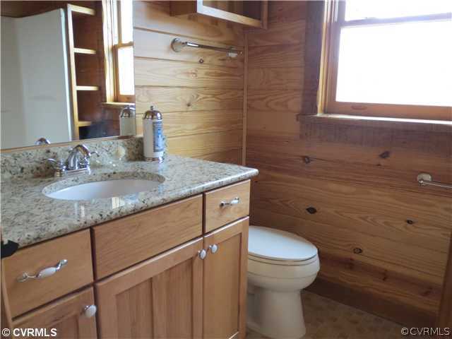 414 Buffalo Church Road Pamplin, VA 23958 - Photo 15 of 19 a bathroom with a granite countertop sink toilet and a mirror