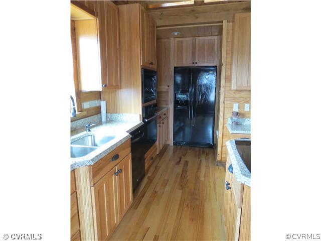 414 Buffalo Church Road Pamplin, VA 23958 - Photo 9 of 19 a kitchen with a sink and a refrigerator
