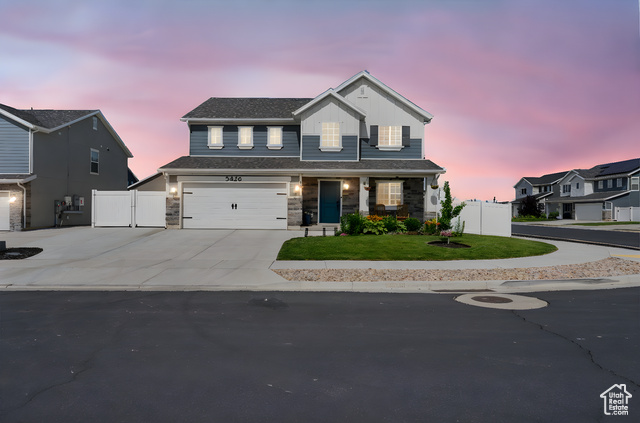 3456 South Linden Way Syracuse, UT 84075 - Photo 50 of 50 View of front facade with driveway, an attached garage, stone siding, a gate, and board and batten siding